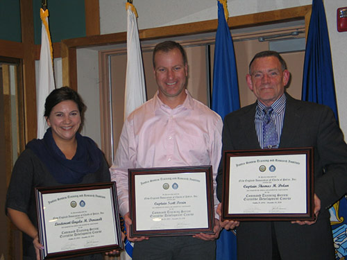 three people holding framed certificate awards
