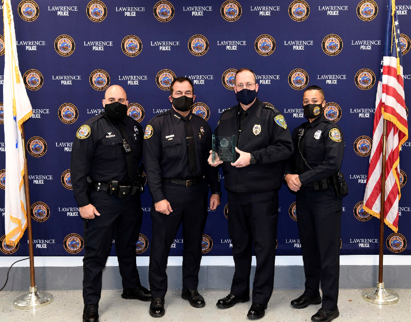 Four uniformed police officers accepting award