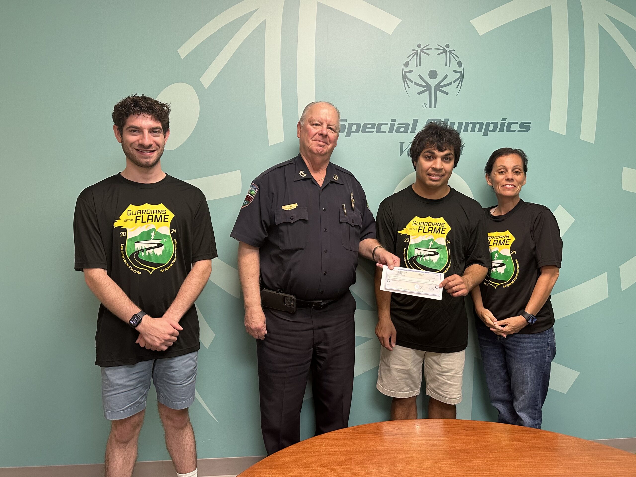 Police Chief presenting check to Special Olympics representatives